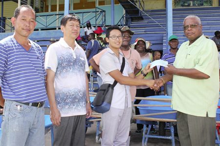 Baishanlin’s Forestry Development Department Director, Eddie Wang (third from left) handing over the cheque to Horace James.
