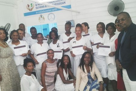 The graduating nurses from the week-long training in oncology at the Georgetown Hospital in the company of OSHAG President Carol Trim-Bagot (standing, left), Oncologist Dr Theophilus Lewis (standing, right), OSHAG Health Care Coordinator Kareen Lambert (stooping, right) and other OSHAG members.