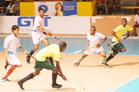 Jamarj Assanah of Hikers (centre) in the process of making a pass to team mate Robert France while being pursued by three National u-19 players during his side’s win.