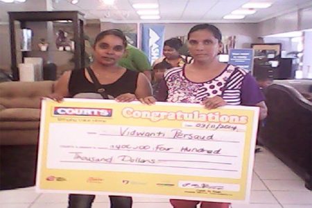 Vidwanti Persaud (left) and her mother showcasing the winning cheque.