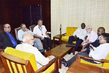 President Donald Ramotar (back to camera) and Finance Minister, Dr. Ashni Singh (right) meeting  executives of the Private Sector Commission (GINA photo)
