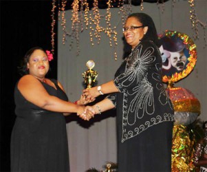 Ayanna Waddell, Best Director for Guilty Pleasures receives an award from Hilary Brown. 
