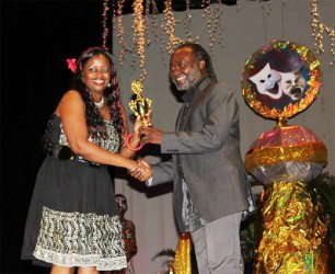 Nicola Moonsammy, who was awarded is the Best Director for her work in Chupucabra receives an award from Russell Lancaster 