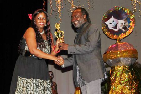 Nicola Moonsammy, who was awarded is the Best Director for her work in Chupucabra receives an award from Russell Lancaster

