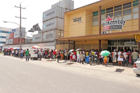 The line of persons outside the Western Union Money Transfer Office in Water Street just after midday yesterday.
