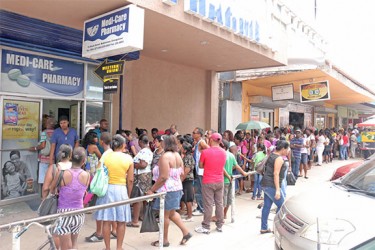 Parents and guardians queuing up outside Medi-Care Pharmacy on Hincks Street, Robbstown yesterday afternoon. 