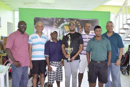 Flashback: George Bulkan (with Trophy) and members of the Underdogs team post with officials of Banks DIH and Citizens Bank at the Presentation Ceremony in February.