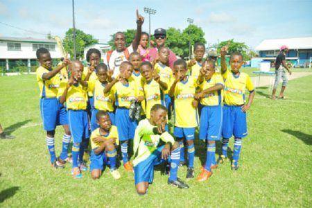 The Defending champions St Pius’s football team celebrates following their emphatic win yesterday over Tucville Primary in yesterday’s semi-final of the Petra Organisation/Courts Pee Wee football tournament. (Orlando Charles photo)

