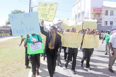 Alliance for Change (AFC) members Khemraj Ramjattan, Trevor Williams and Moses Nagamootoo led a procession of protestors in front of the Parliament Building yesterday. (Photo by Arian Browne)