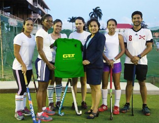 National Vice-Captain Ulrica Sutherland (second left) receiving the symbolic team uniform from GT&T PRO Nadia DeAbreu while teammates (from left to right) Kerensa Fernandes, Marian Munroe, Tricia Woodroffe, Ashley DeGroot and coach Peter DeGroot look on 