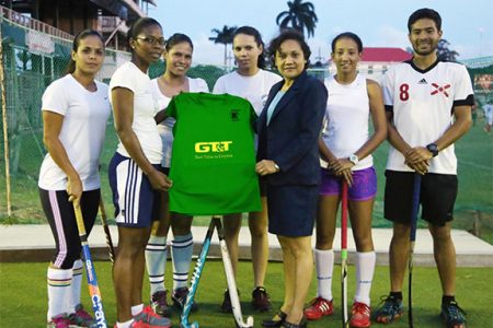 National Vice-Captain Ulrica Sutherland (second left) receiving the symbolic team uniform from GT&T PRO Nadia DeAbreu while teammates (from left to right) Kerensa Fernandes, Marian Munroe, Tricia Woodroffe, Ashley DeGroot and coach Peter DeGroot look on 