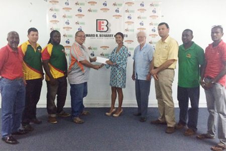 Director of Edward B. Beharry and Company, Anjali Beharry-Strand presenting the sponsorship cheque to president of the GRFU, Peter Green.