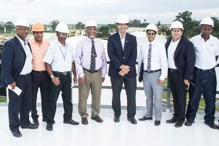 Prime Minister Sam Hinds (fourth from left) and Mauricio Nicholls (fifth from left) with other officials