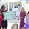 Carol Pogue presents the first donation to the Dr. Oliver Pogue Memorial Charity Fund  to Chief Executive Officer Beverly Braithwaite–Chan (GINA photo)