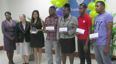 ‘Republic Bank’s ‘Deal on Wheels’ winners display their gift certificates while the bank’s representatives Vanessa Thompson (first, left) and Patricia Plummer (second, left) look on.  