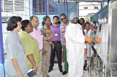 Staff of the Georgetown Public Hospital Corporation looking on as the technician explains parts of the machinery. (GINA photo) 