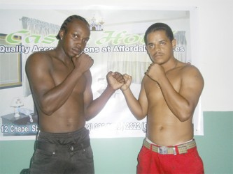 Richard Williamson (left) and Delon Allicock square off following the conclusion of the contract signing for the vacant national super bantamweight title fight. 