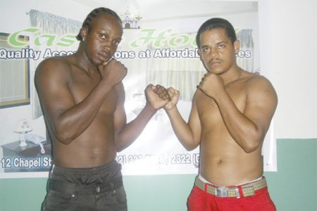 Richard Williamson (left) and Delon Allicock square off following the conclusion of the contract signing for the vacant national super bantamweight title fight.

