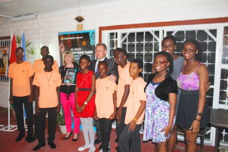 Child rights:  Members of the Lodge Secondary School’s steel pan orchestra along with EU Ambassador Robert Kopecky and UNICEF’s Country representative Marianne Flach (fourth from left) pose with a copy of the Child Rights Toolkit which was launched last evening, on the eve of the 25th anniversary of the Convention on the Rights of the Child, at the Bel Air Springs residence of the EU Ambassador. 