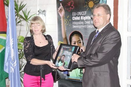 EU Ambassador Robert Kopecky (right) and UNICEF’s Country representative Marianne Flach with a copy of the Child Rights Toolkit.
