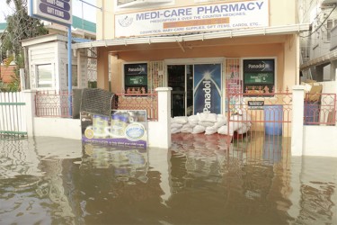 Medi-Care Pharmacy taking the necessary measures to avoid the floodwater 