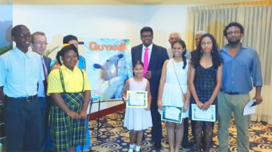 Explore Guyana 2015: The winners of the essay competition held by the Tourism and Hospitality Association of Guyana (THAG) at the launch of the 15th edition of Explore Guyana magazine, with the President of THAG Shaun McGrath, THAG vice-president Andrea de Caires, Tourism Minister Irfaan Ali, Explore Guyana Publisher Lokesh Singh, Chairman of Gecom Dr Steve Surujbally and author Ruel Johnson. 