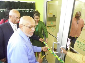 President Donald Ramotar (second from left) cutting the ribbon to declare the branch open. At left is the bank’s Chairman Clifford Reis. 