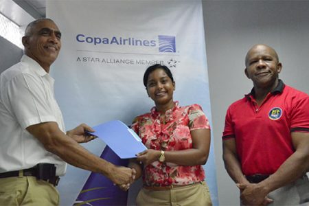 Guyana’s sales manager for Copa Airlines, Nadine Oudkerk, hands over the letter of commitment to Flex Night’s Director of External Resources, David Gomes as Managing Director of Flex Night Inc. Donald Sinclair looks on.
