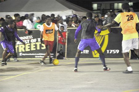 Joey Garrett (second from left) of D’urban Street trying to evade Hope Street Tiger Bay’s Dwayne Dickson (left) and Calvin Shepherd during their side’s group-D matchup