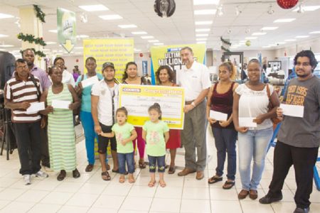 From left to right front row are: Aubrey King, Christine Douglas, Maxwell Boyer, Boyer’s daughters, Courts Guyana Inc Managing Director Clyde de Haas, Tina Baldeo, Annalisa Brummell and Yogeswar Gobin. Back row left to right are Courts employees, Andrea Burke, Boyer’s wife and mother.
