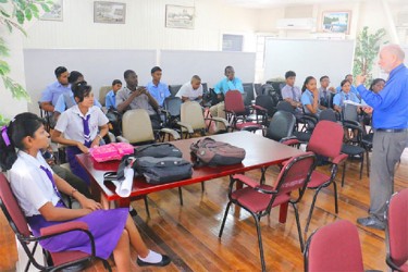 Participants of the Sagicor Visionaries’ finals listening to judge Doug Hall as he explains the rules of the competition at the National Centre for Education Research and Development. 