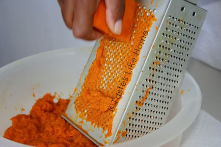 Grating pumpkin for Conkies (Photo by Cynthia Nelson)