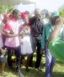 Shonette Adams, Shaquille Grant’s mother is assisted out of Agricola ball field by Opposition Leader David Granger (right) and Kevin Fields (left) on the day of Grant’s funeral