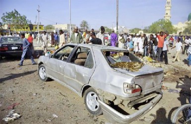 A car is seen damaged at a scene of multiple bombings at Kano Central Mosque November 28, 2014. Credit: REUTERS/Stringer