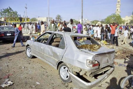 A car is seen damaged at a scene of multiple bombings at Kano Central Mosque November 28, 2014. Credit: REUTERS/Stringer