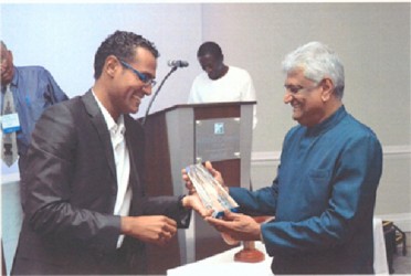 Dr Steve Surujbally receiving the Distinguished Veterinarian Award from  Dr Paul Crooks, President of the Caribbean Veterinary Medical Association 