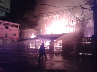 The Robb and King streets building engulfed in flames this morning. Firemen could be seen directing a hose at the fire.