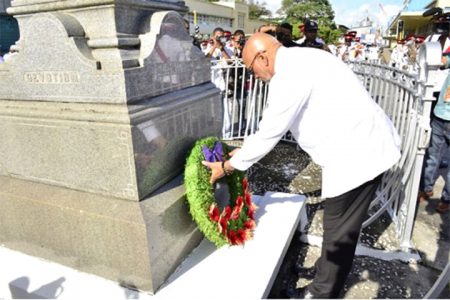 Head of State, Donald Ramotar laying a wreath at the Cenotaph in observance of the fallen heroes of World Wars One and Two (GINA photo).
