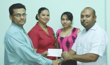 Brian Pertab Shipping Manager of Maersk (left) hands over the sponsorship cheque to LGC President David Mohamad in the presence of Maersk staff. 