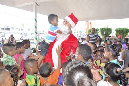 Children with Santa at one of the parties (Massy Group photo)