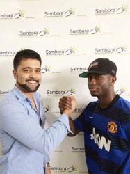 GFC Manager Faizal Khan (left) shakes hands with Trayon Bobb, his club’s newest signee.  