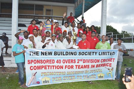 Rana Persaud, NBS Rose Hall Manager (left) presents the winner’s trophy to D’Edward Captain Jaipaul Heeralall as other NBS staff, players from the victorious team and BCB officials look on. 