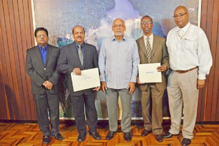 President Donald Ramotar (centre) is flanked, from left, by Minister of Finance Dr Ashni Singh, Governor of the Bank of Guyana Dr Gobind Ganga, Deputy Govenor Leslie Glen and Minister in the Ministry of Finance Juan Edghill.  