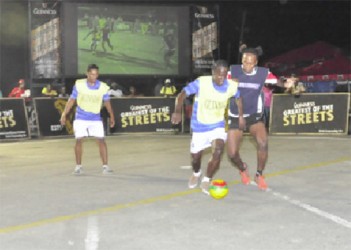 Odell Williams of Festival City Street Fighter’s (right/blue vest) trying to dispossess Omallo Williams (centre/yellow vest) of Leopold Street from possession of the ball during their matchup