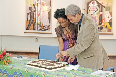 Stanley Greaves cuts his birthday cake at a ceremony held in his honour at Castellani House last month. 