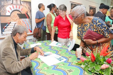 Signing a catalogue for a fan 