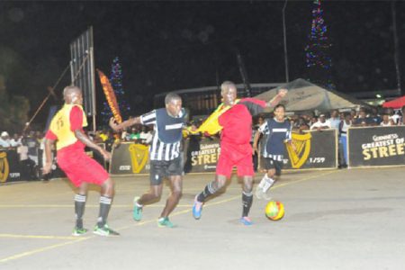North Ruimveldt’s Joshua Browne (second from right) trying to keep possession of the ball while being challenged from Kevin Lewis (third from right) of Globe Yard during their quarterfinal showdown