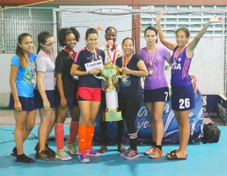 Women champions GCC Tigers displaying their winners trophy and medals at the conclusion of the event.   