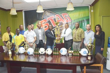  Stag Beer Brand Manager John Maikoo (third from left in foreground) and Normalization Committee President Clinton Urling (to the right of him) share the moment with Franklin Wilson (fifth from right) and ANSA McAl Marketing Director Troy Cadogan who are holding the winner’s trophy.  