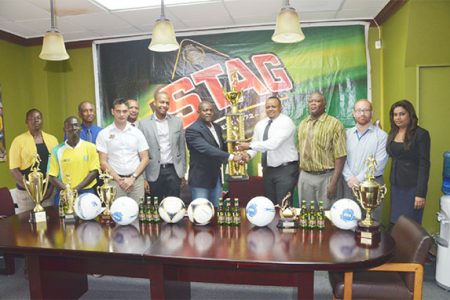  Stag Beer Brand Manager John Maikoo (third from left in foreground) and Normalization Committee President Clinton Urling (to the right of him) share the moment with Franklin Wilson (fifth from right) and ANSA McAl Marketing Director Troy Cadogan who are holding the winner’s trophy.
